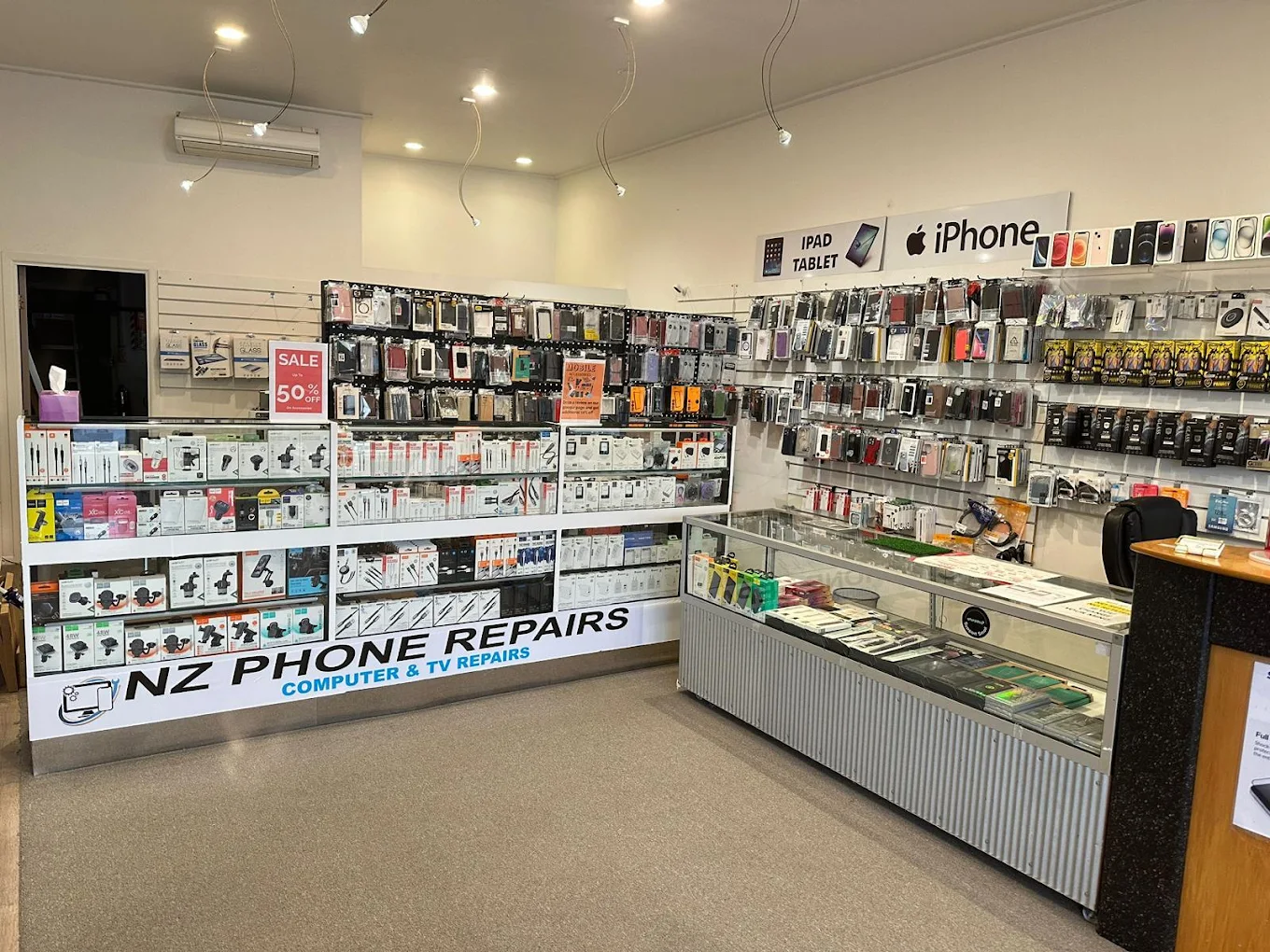 NZ Phone Repairs technician carefully repairing a smartphone at our Mount Eden store